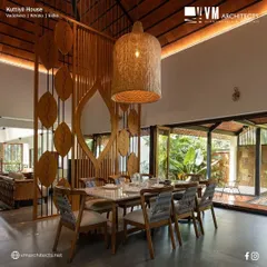 The dining area in Kuttiyil House is defined by this custom-designed wooden partition. The leaf motif adds an artistic, natural element while creating a sense of separation from the living area without closing off the space, maintaining an open and connected feel.