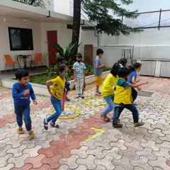 Kids playing a fun, active math game in the courtyard. I believe in getting kids moving to help concepts stick, turning our space into a giant, playful calculator.