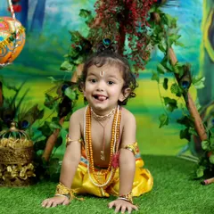 A cheeky and adorable expression that perfectly captures the playful spirit of Little Krishna. The vibrant colors of the set make this a joyful and memorable portrait.