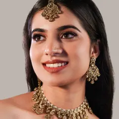 Here, the makeup is consistent but the jewellery changes, showing how a versatile base look can work for an entire product line. The defined eyes and flawless skin provide a perfect canvas for this statement necklace set.
