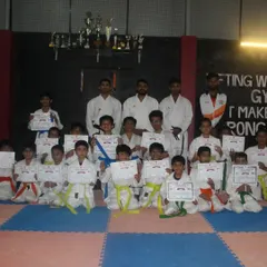 The reward for discipline and perseverance. Our students proudly display their new belts and certificates after a challenging belt grading test. Each certificate represents hours of practice and a new level of skill achieved.