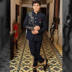 A full-length look at the hand-embroidered navy blue Bandhgala suit. Paired with tailored trousers and classic loafers, this outfit is a complete statement of modern Indian elegance for any formal event.