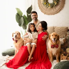 A beautiful family portrait announcing "It's a Girl", with the whole family, including their adorable fur babies, sharing in the excitement.