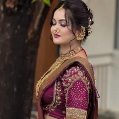 The side profile shows how the Navari drape complements the embroidered blouse and hairstyle. Every detail is considered to create a cohesive and stunning bridal appearance.