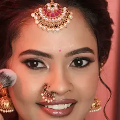A close up of this bride's beautiful smile and makeup. The focus is on the clean, defined eye makeup with a sharp wing and a perfectly applied nude lipstick.