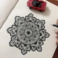 A classic black and white mandala in progress. I use fine-tipped pens to create the clean, intricate linework that forms the foundation of these meditative patterns.