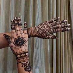 Showcasing my versatility with two distinct styles. One hand features a modern, bold Om symbol within a lotus mandala, while the other displays a classic, intricate checkerboard (jaal) pattern.
