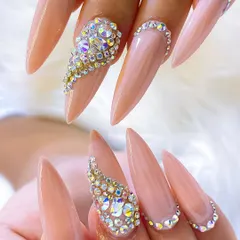 A close-up of the Swarovski crystal placement, showing the precision required to create these intricate, light-catching patterns. This is a key skill for any bridal nail artist.