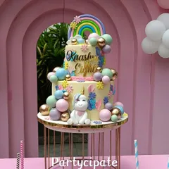 A magical, three-tiered unicorn cake for Kaashni's 8th birthday. The cake is decorated with a pastel rainbow, fluffy clouds, and a sweet unicorn topper.