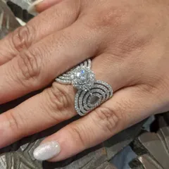 The beauty of a custom diamond ring on the hand. This piece, with its sparkling 1-carat solitaire and intricate pavé band, is crafted in 18kt gold and designed to be a cherished symbol for years to come.