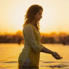 Offering the sacred water of the Ganga back to its source. This simple act of reverence is a way of acknowledging the life-giving power of the river and the divinity within all of nature.
