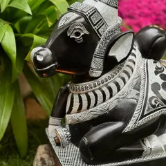 The fine, contrasting details on this seated Nandi statue are highlighted here, showing the beautiful craftsmanship that goes into each piece.
