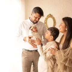 The whole family admiring their newest member. This is a beautiful lifestyle portrait capturing the love and awe of welcoming a newborn home.