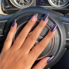 A deep, moody purple chrome set with a single accent nail featuring delicate rhinestone details.