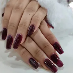 Your nails are a canvas. This deep wine, glossy manicure is perfect for making a statement, whether at a festive event or in the boardroom. It’s a sophisticated and confident look, like the perfect red lipstick for your hands.