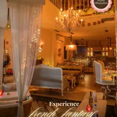 This wide view showcases the "French Fantasy" I aimed to create. You can see the elegant chandelier, vintage furniture, and the unique bathtub dining area, all bathed in a warm, inviting glow.