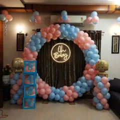A straight-on shot of the classic pink and blue baby shower decor. The neon "Oh Baby" sign provides a modern focal point, while the balloon colors are perfect for a traditional theme or a gender reveal.