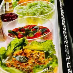 A fresh and vibrant salad bar. I offer a selection of crisp greens, fresh vegetables, and delicious dressings, providing a healthy and colorful option for guests.