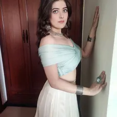 For the song 'Haule Haule', I styled a soft, romantic, indo-western look. This ensemble features a draped, off-shoulder top in powder blue paired with a flowing white skirt and chunky silver jewelry for a bohemian touch.