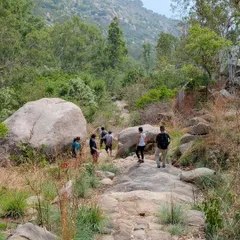 The crew navigating a beautiful, boulder-strewn path at Bidarakatte. This is a great example of the kind of beginner friendly trails we explore.