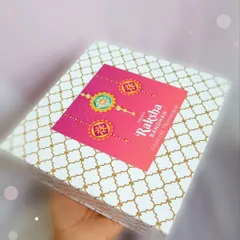 Holding up a finished Rakshabandhan hamper. The festive design on the box makes it a perfect gift to celebrate the sibling bond.