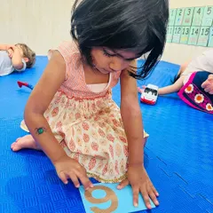 This child is using sand tracing to learn the number nine. This multi-sensory technique, which I teach in my workshops, helps make number recognition a memorable and physical experience.