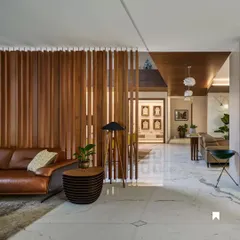 A vertical wooden slat partition in the Kanasu project. This element elegantly defines the living space while allowing light and views to pass through, maintaining an open feel.