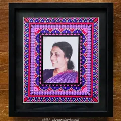 The finished mandala-framed photograph, presented in a classic black frame. The vibrant pink and purple patterns of the mandala beautifully complement the photo within.