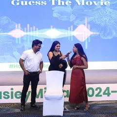 Engaging with participants during a "Guess the Movie" game at a corporate event. Interactive sessions are a great way to break the ice and make company events more memorable.