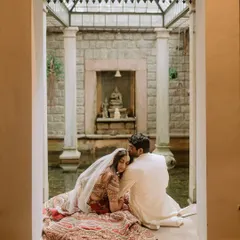 An intimate moment of quiet connection for a newlywed couple by our indoor courtyard pond. We believe in creating spaces where you can steal away a moment for just the two of you.