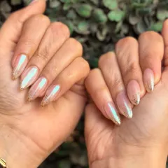 Subtle elegance perfect for an engagement or wedding. These nails feature a pearlescent chrome finish over a nude base, with a delicate gold glitter fade at the tips.
