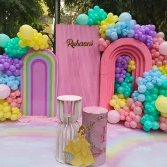 A modern pastel rainbow and princess-themed backdrop for Ruhaan's party, featuring Belle from Beauty and the Beast.
