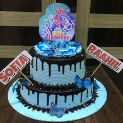 A two-tier Choco-Blueberry cake with a striking blue color and rich chocolate drip. This is a great choice for a shared birthday celebration.