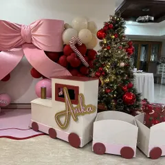 Anika's Christmas train, personalized with her name, served as a wonderful prop and a place to hold gifts, adding to the festive magic.