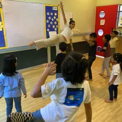 This dynamic shot captures the energy of a group movement exercise. We teach children to use their entire bodies to express themselves, building physical confidence and stage presence.