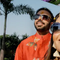 A cool and casual selfie-style shot of the couple during their outdoor haldi, capturing their relaxed and happy vibe.