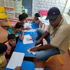 Our mentor Ashok Urs teaches a group of eager children the basics of bookbinding. This hands on activity teaches precision and patience, and the kids leave with a book they made themselves.