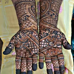 A classic semi-bridal look with a mix of paisleys, checks, and floral patterns. The dark, bold application ensures the design stands out beautifully.
