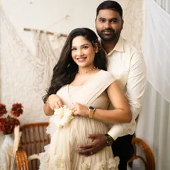 A sweet shot of the mother-to-be holding a pair of tiny baby shoes. This pose is a beautiful way to symbolize the little one who is on the way.