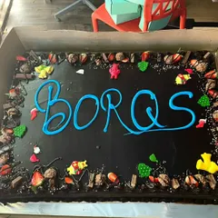 A massive, fully loaded chocolate cake for a corporate team celebration. We can customize the message and toppings to match your company's event.