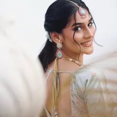A stunning engagement bridal inspiration shot, with a focus on the beautiful smile and pastel lehenga.