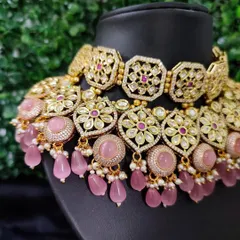 A close-up of the choker, highlighting the floral kundan motifs and the soft pink stone drops.
