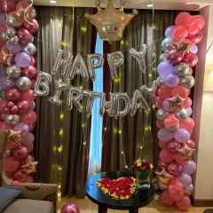 This version of the setup includes a heart-shaped arrangement of red roses on the table, adding an extra touch of romance to the beautiful birthday decor.