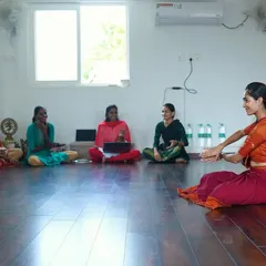 A moment of discussion and learning during a group session. The studio's quiet and focused environment is conducive to both practical instruction and theoretical lessons.