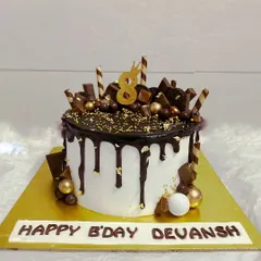 A delicious vanilla cake loaded with chocolate bars, wafers, and Ferrero Rocher.