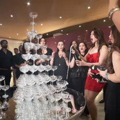 A moment of celebration with a champagne tower. This interactive element adds a touch of glamour and excitement to any corporate event or anniversary party.