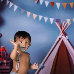 The aftermath of a fun cake smash is always full of giggles and adorable, messy faces. This little boy is having the time of his life celebrating his first birthday.