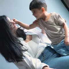 A candid, heartwarming moment between a mother and her son, showcasing a natural and playful interaction. This is an example of our "mom & me" family bonding photo sessions.