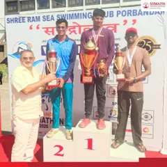 Varad Ghanshyam Kuvar stands on the podium after securing second place in a challenging 15 km swimming event organized by Shree Ram Sea Swimming Club.
