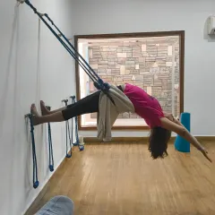 Let's choose to be grateful right now. A student in a beautiful backbend, suspended by the wall ropes, opening her heart with abundance.